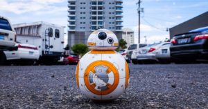 Picture of star wars bb-8 in the middle of the road in front of a building. Robots can help with Marketing automations too